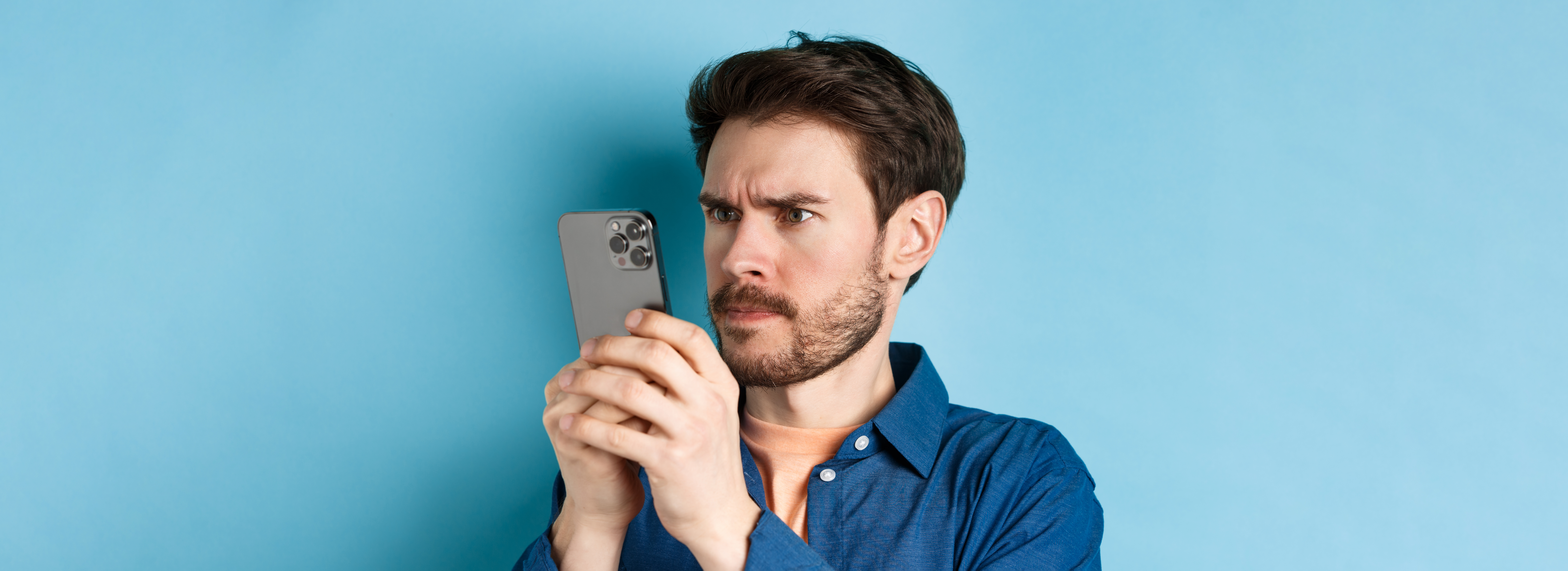 Homem confuso olhando para o celular